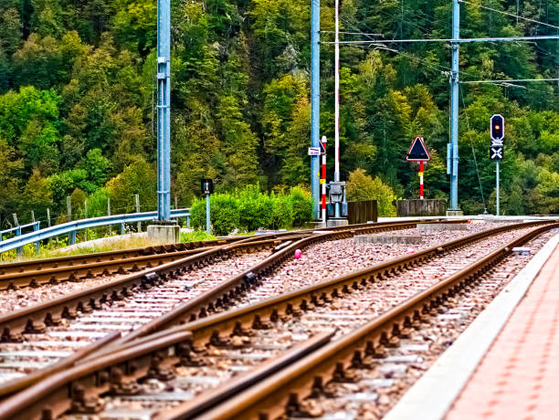 Railroad track with gravel and signals at the station in the village of Camedo - part of the Swiss municipality of Centovalli, located in the canton of Ticino