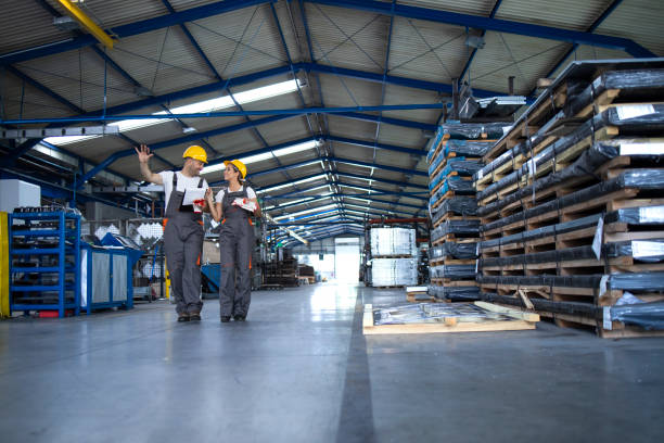 istock Factory employees walking in industrial production hall. 1281782565