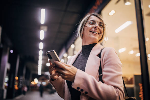istock Woman standing next to store window and using smart phone 1281784167