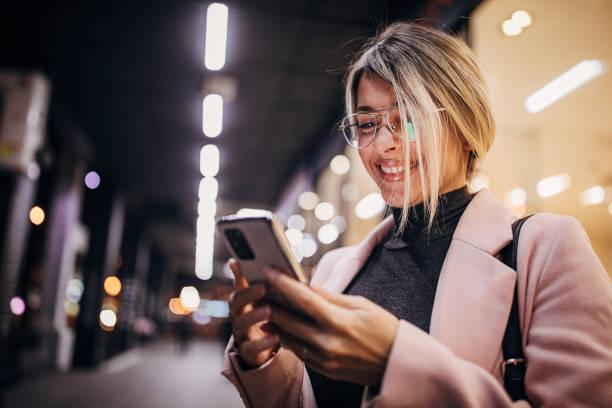 istock One beautiful happy woman standing next to store window and using smart phone 1281784214