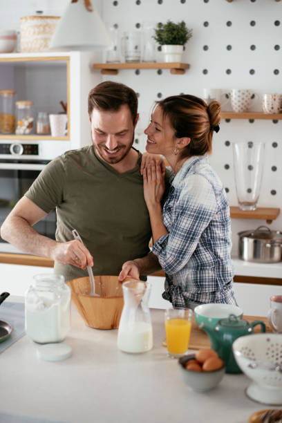 istock Husband and wife making pancakes at home. 1281785141