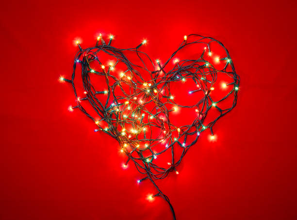 istock Heart shaped Christmas lights on red 1281786345