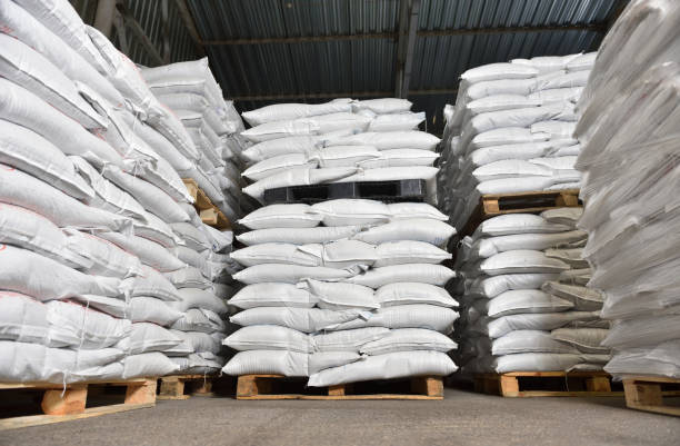 istock Warehouse filled with white heavy bags that lie on pallets 1281789070