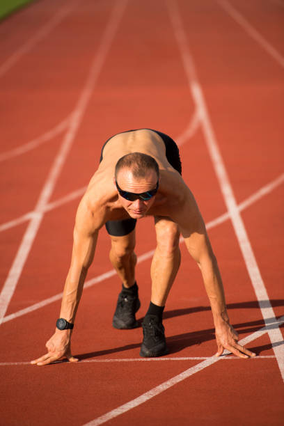 istock Male runner preparing for the start on the track 1281791032