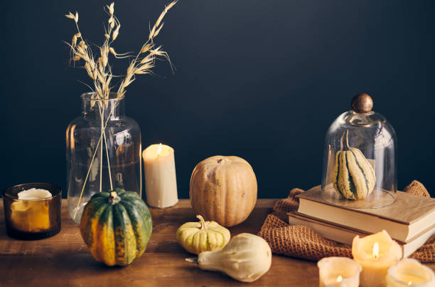 istock Halloween pumpkin on a table with glasses in a moody ambient 1281791649