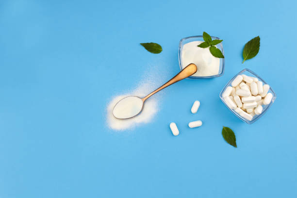 istock Collagen protein powder and collagen pills on blue background. 1281793878