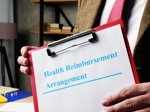 Man proposes Health Reimbursement Arrangement HRA documents.