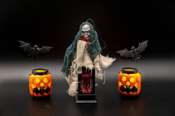 istock Halloween stuff composition with flying witch on an old black lantern, lightned pumpkins and bats on the background. 1281795791