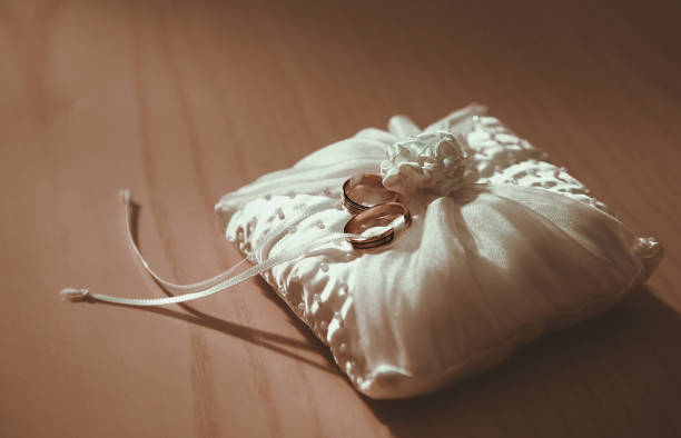 istock Golden rings on a white pillow 1281798160