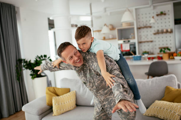 istock Soldier having fun with his son at home. 1281799312