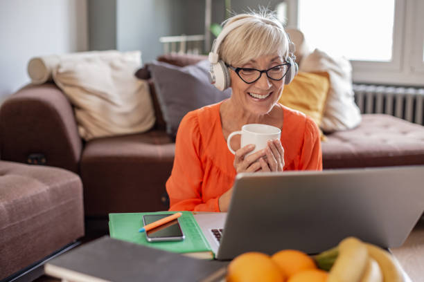 istock Senior woman working from home and using laptop 1281799503