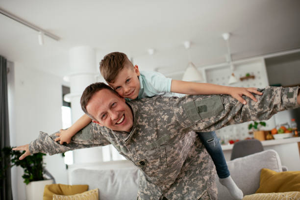 istock Soldier having fun with his son at home. 1281799596