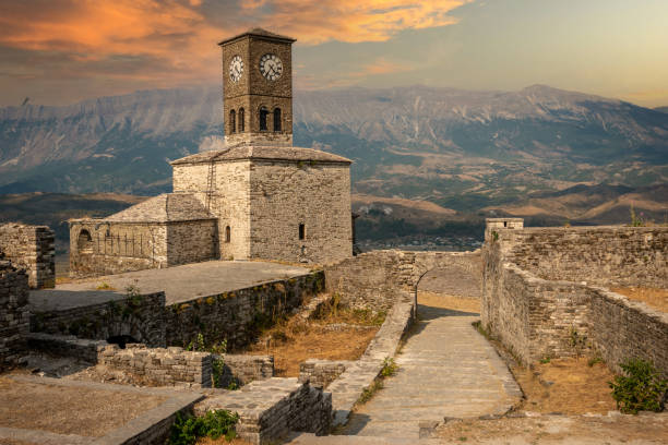 Sunset over clock tower and fortress at Gjirokaster castle, Albania stock photo