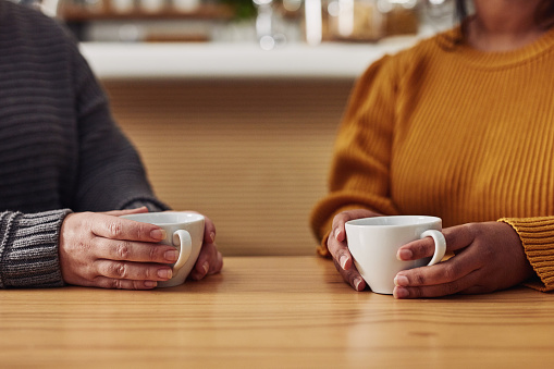 Cropped shot of two unrecognizable women having coffee in a cafe