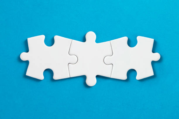 Connection Concept with White Puzzle Pieces White puzzle pieces comes together on blue background. jigsaw piece photos stock pictures, royalty-free photos & images