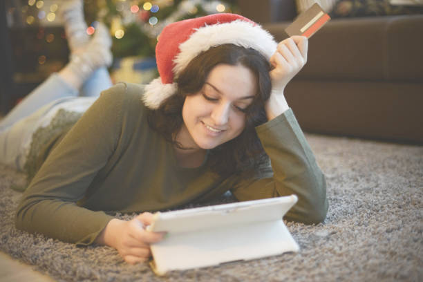 istock young woman in christmas interior with laptop  ( e-commerce) 1281800280