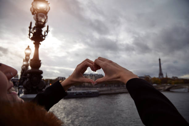 istock Girl using cellphone with Paris city background, Seine river and Eiffel tower. 1281801301