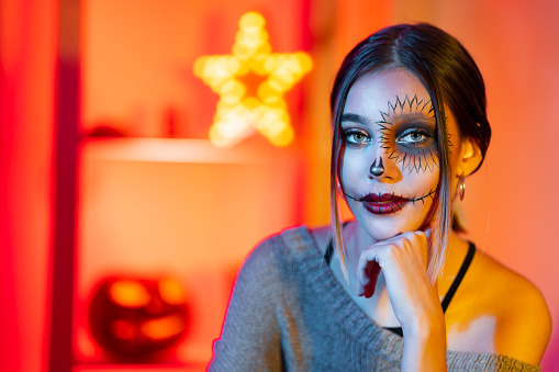 Portrait of attractive girl in both scary and beautiful Halloween costume.