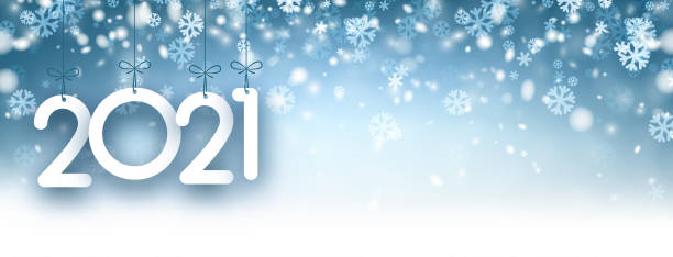 istock 2021 paper sign hanging on ribbons on snowy background. 1281803547