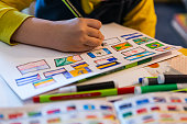 child draws flags of world countries at home.