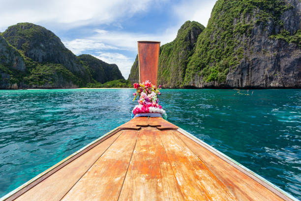 istock Traditional longtail boat with beautiful scenery view at Maya Bay on Phi Phi Leh Island in sunshine day. 1281811415