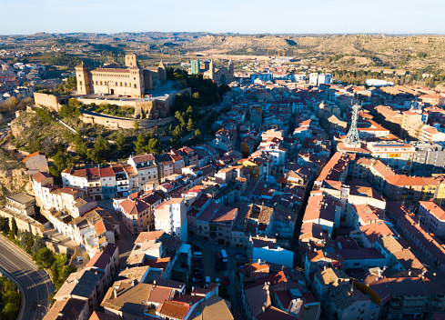 Aerial view of ancient fortified castle of Calatrava on background of Alcaniz cityscape in sunny autumn day, Spain