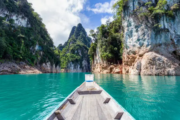 Photo of Traditional longtail boat with beautiful scenery view in Ratchaprapha Dam at Khao Sok National Park.