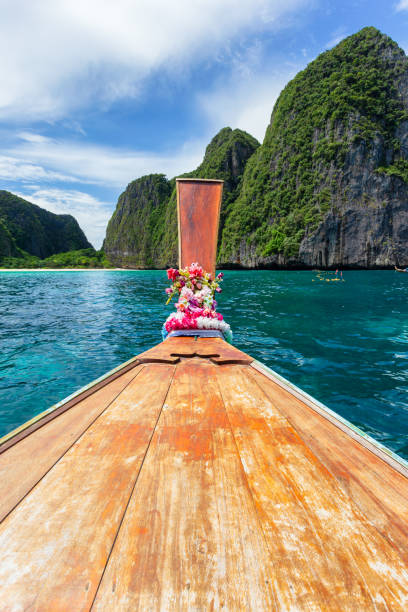 istock Traditional longtail boat with beautiful scenery view at Maya Bay on Phi Phi Leh Island in sunshine day. 1281812192