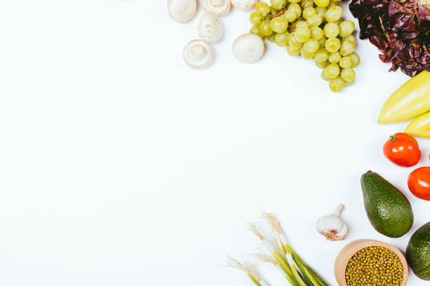 istock Clean eating background fresh vegetables and fruits on white table 1281813359