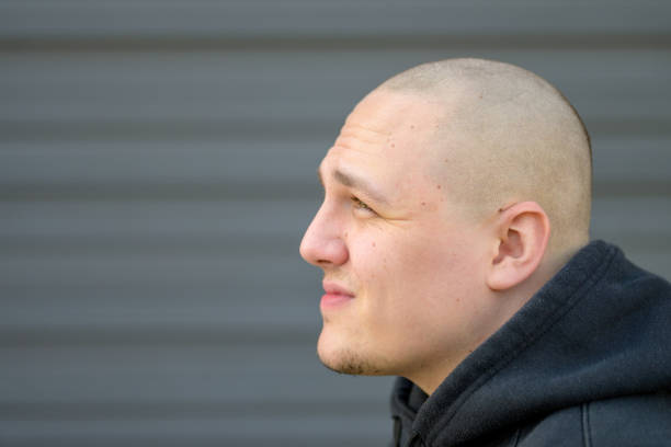 istock Profile of a casual young man with shaved head 1281813494