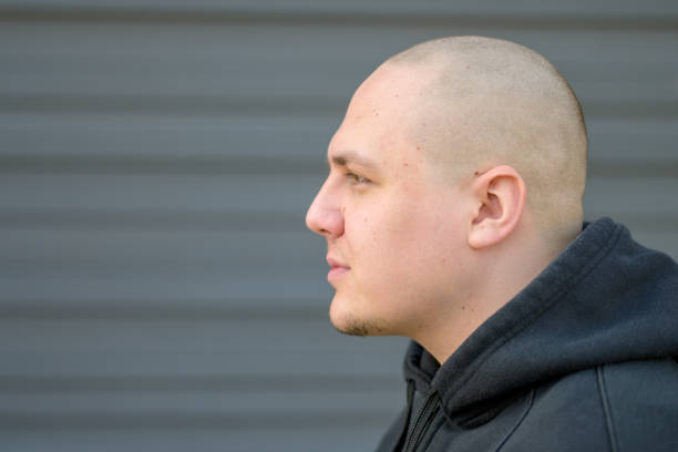 istock Profile of a modern young man with shaved head 1281814136