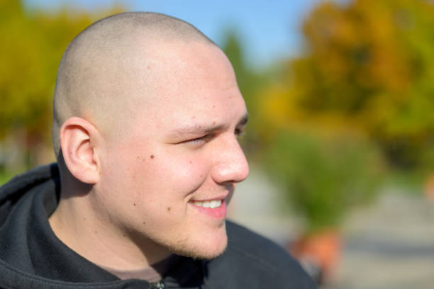 istock Smiling young man with shaved head outdoors 1281814301