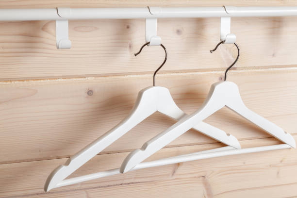 istock Two white hangers are near blank wooden wall 1281814666