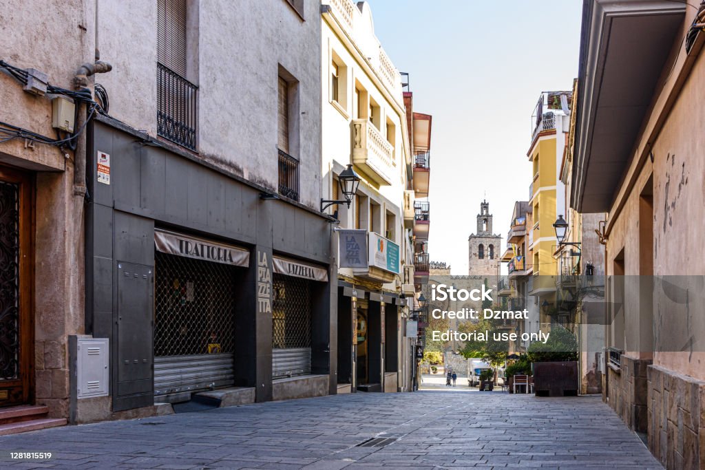 street at Sant Cugat downtown with monastery on the background Sant Cugat del Valles- Catalonia, SPAIN - 10/23/2020: view of pedestrian street at city downtown with monastery on the background 2020 Stock Photo