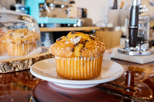 Close up tasty appetizing muffin or cupcake on cafe background.