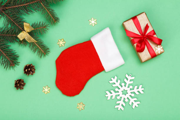 istock Santa's boot, gift box, fir tree branches with cones and snowflackes 1281818038