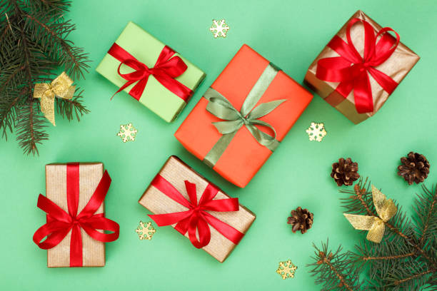 istock Gift boxes, fir tree branches with cones on green background 1281818046