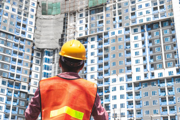 istock A man in a position of engineer wearing a safety helmet is checking work at the construction site 1281819582