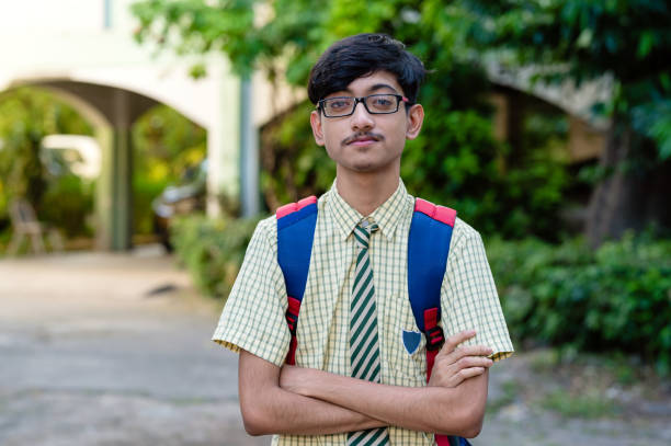 istock Young high school school boy in uniform and carrying bag 1281821678