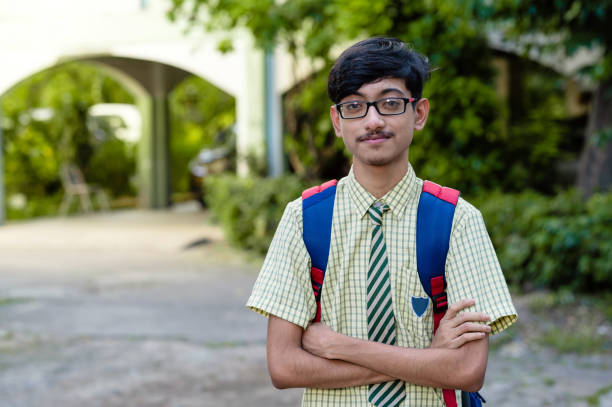 istock Young high school school boy in uniform and carrying bag 1281821821