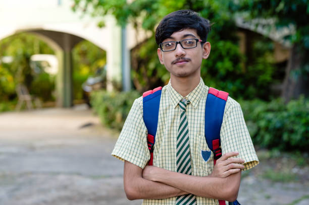 istock Young high school school boy in uniform and carrying bag 1281821864