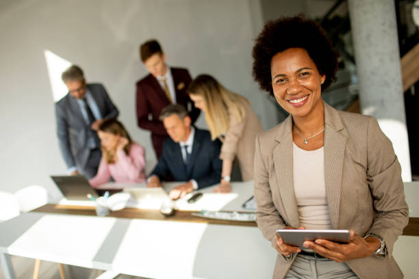 istock African American businesswoman standing and using digital tablet in a modern office 1281823639