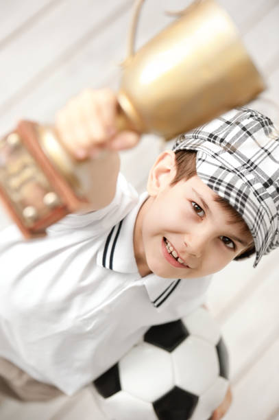 istock Portrait of a boy with a cup champion 1281823859