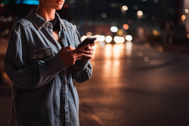 istock Beautiful woman using smartphone outdoors 1281825144