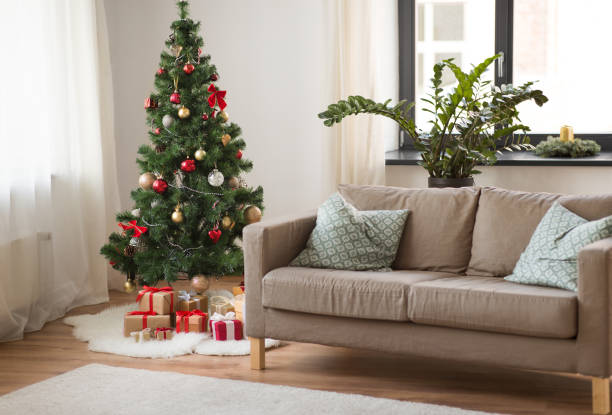 istock christmas tree, gifts and sofa at cozy home 1281827591