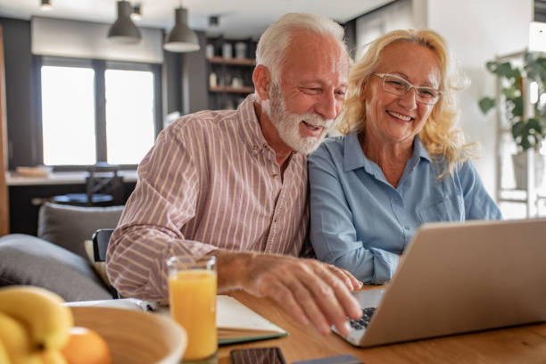 istock Senior couple with laptop at home 1281827851