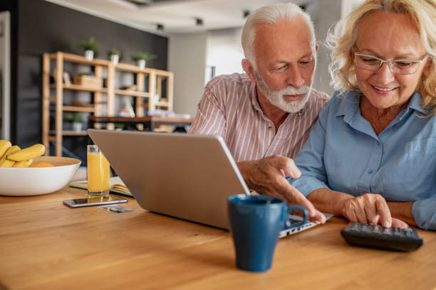 istock Senior couple with laptop at home doing home budget 1281827870