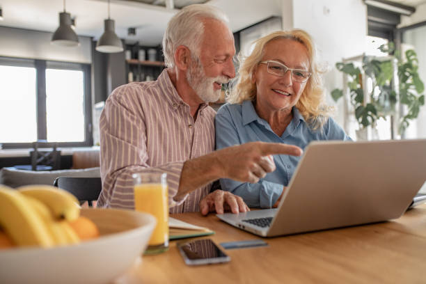 istock Senior couple with laptop at home 1281827948