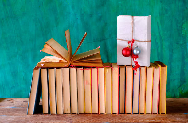 istock books as christmas gift,christmas present,reading,literature,education,making a gift concept 1281828385