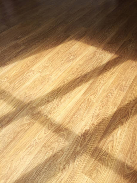 istock Reflection of sunlight through a window on a parquet wooden floor 1281829723